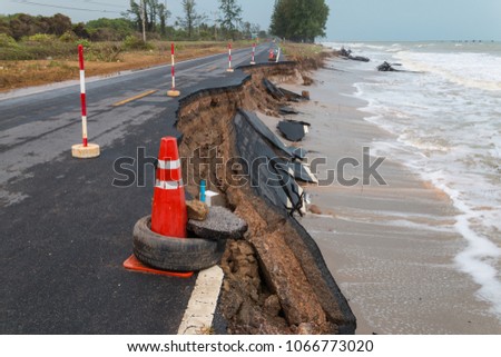 Waves of sea erode the road. Royalty-Free Stock Photo #1066773020