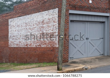 faded painted sign on rustic old brick wall texture store or building ready for copy