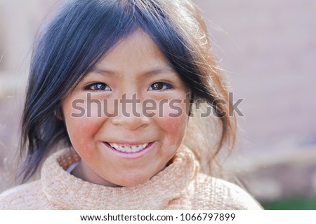 Pretty little latin girl smiling happily outside. Royalty-Free Stock Photo #1066797899