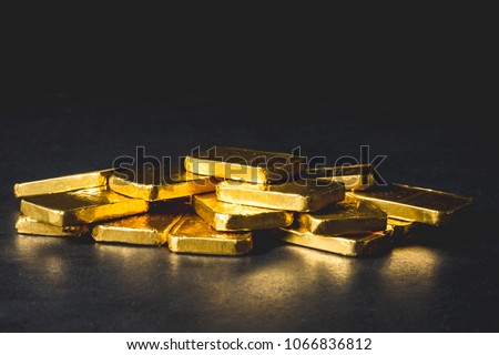Stack of Pure gold bars on black background Royalty-Free Stock Photo #1066836812