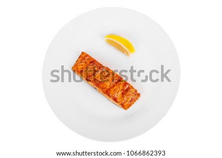 Fish, trout, keta, pink salmon, a piece, baked, fried over an open fire, with a slice of lemon. Appetizing, juicy, natural, on white isolated background View from above For the menu, restaurant, bar Royalty-Free Stock Photo #1066862393