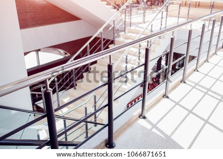 Staircase in modern buisness center building. Emergency evacuation exit. Stairs in shopping mall. White ladder by window in hotel. Urban architecture.