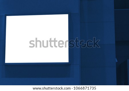blank showcase billboard or advertising light box on wall for your text message or media content at airport or subway train station, advertisement, commercial and marketing concept, blue color tone