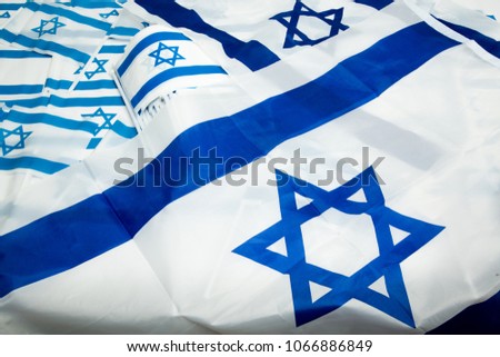 Israeli flags and small items with national colors on a white background