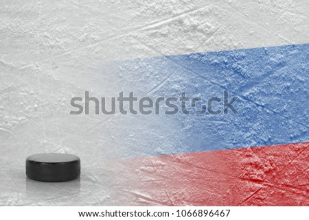 The image of the Russian flag and on ice and a hockey puck. Concept, hockey