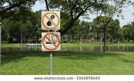 Forbidden sign: no smoking and don't pick the flowers at public park on white background and red circle