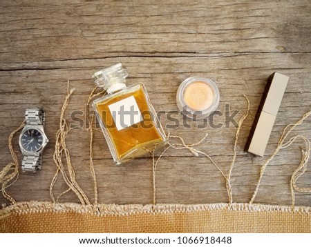 Topview of cosmetic makeup collection warm tone for sumer look on wood table background,vintage tone.