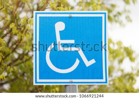 Parking for disability persons sign on the tree background