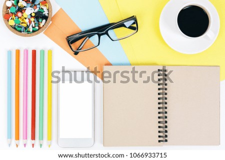 Mix of office supplies and gadgets on working white desk top with other items. Top view. Mock up 