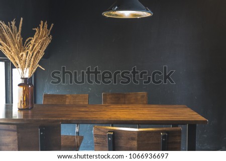 Dark dining table with wooden chair and dry flower in vintage design room Royalty-Free Stock Photo #1066936697