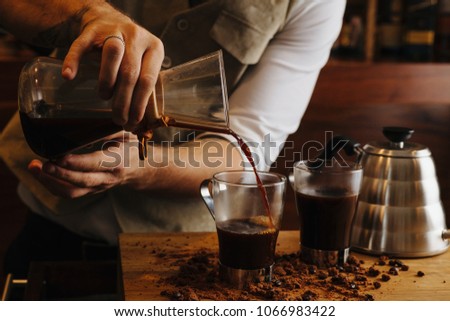 Image of a unrecognizable person making coffee.