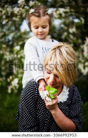 portrait of mother and daughter in Apple trees