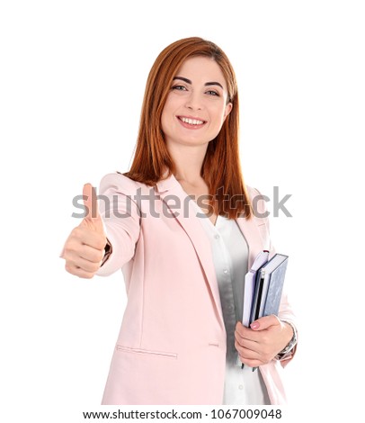 Beautiful young teacher with notebooks on white background