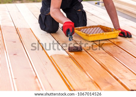 Painting a terrace board impregnation water proofing Royalty-Free Stock Photo #1067014526