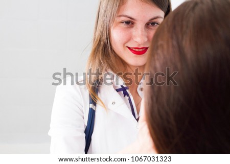 doctor woman close-up looks at patient