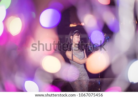 pretty Asian woman night outdoor portrait with bokeh light background.