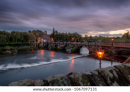 View of Dee river and the Old Dee Bridge in Chester, Cheshire, at sunset, taken from the Chester City Walls Royalty-Free Stock Photo #1067097131
