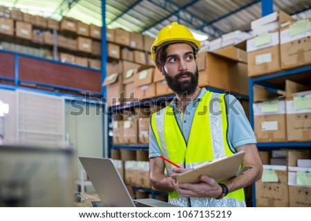 Warehouse worker checking stock products in store