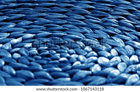 Round straw mat texture with blur effect in navy blue tone. Abstract background and texture for design.