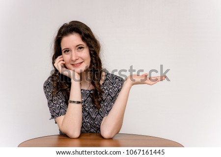 beautiful girl is sitting at the table