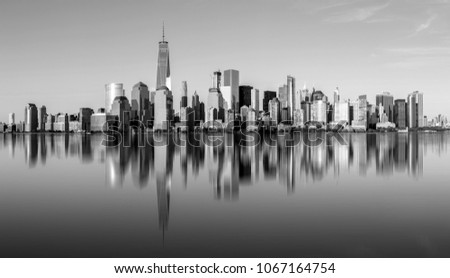 Manhattan skyline with reflections in the water in black and white