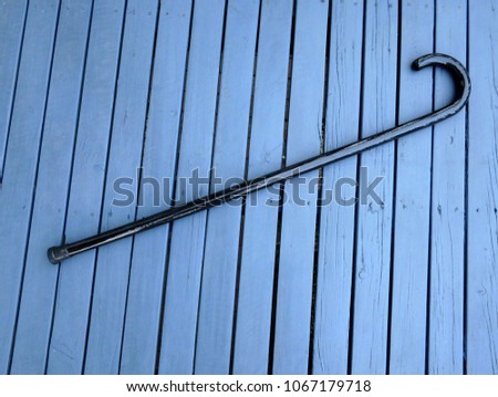 old fashion walking stick cane on a blue wooden deck