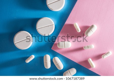 Several types of pills, such as antibiotics, anti-inflammatories. All on blue background