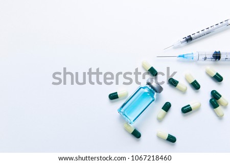 Treatments for orphan disease: medicine pills, syringes, drug vial Royalty-Free Stock Photo #1067218460