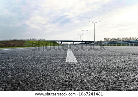 A new road with a dividing strip and lighting poles. Road construction.