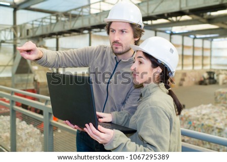 supervisor of a recycle manufacturing business pointing
