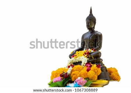 Bronze cast Buddha image decorate with beautiful flowers and garland for pray on Songkarn festival in Thailand separated on white background with clipping path.