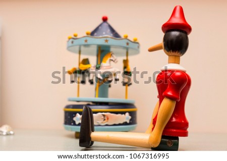 image of wooden puppet with carousel on the background 