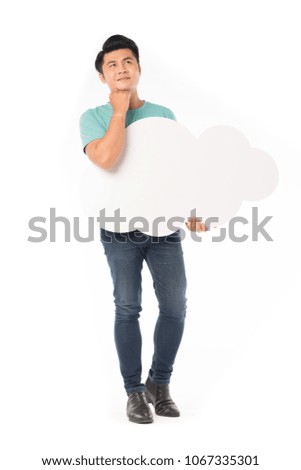 Portrait of young Asian man holding empty cloud bubble isolated on white