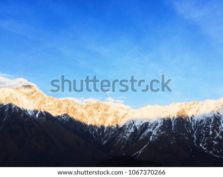 Sunset in the mountains of Kazbegi. Snowy mountains in Georgia . Photo taken on the iPhone