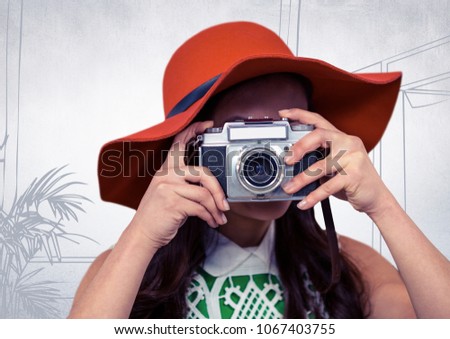 Millennial woman with sunhat and camera against white hand drawn office