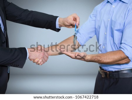 Men holding keys handshake in front of vignette