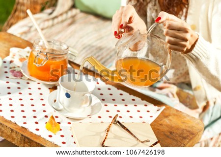 Close up on a woman pouring tea