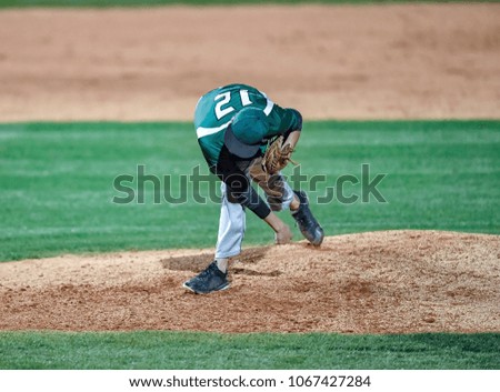 Baseball pitcher throwing a strike across the plate