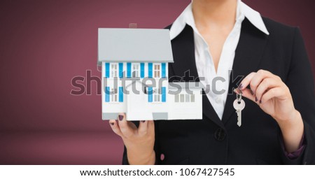 Woman Holding key and house in front of vignette