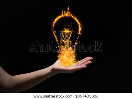 hand with light fire icons over. Black background