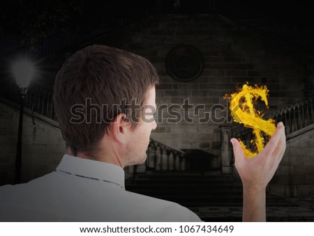 man with dolar fire icon on hand in the city at night