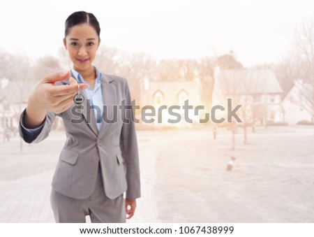 Woman Holding keys in front of houses