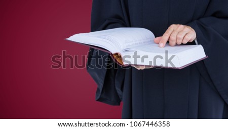 Judge mid section with open book against maroon background