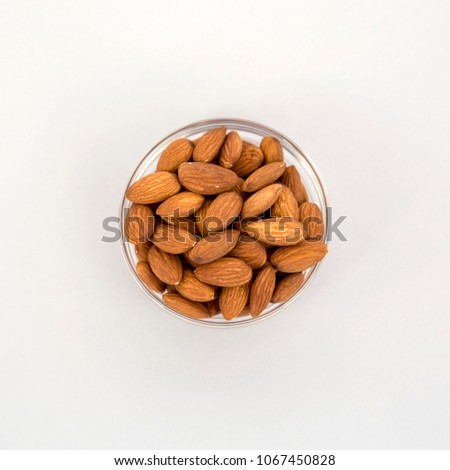 Raw Natural Organic Almonds Nuts in Glass Bowl Isolated on Grey Background Top View Healthy Food for Life Natural Light Selective Focus