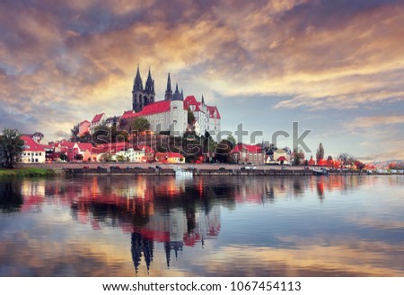 Unsurpassed Colorful Sunset. Wonderful View Albrechtsburg castle and cathedral on the River Elbe in Meissen during golden Hour, Saxony, Germany. Scenic image of townscape. Popular Places photorgaphy.