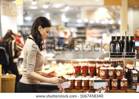 Women choosing a dairy products at supermarket