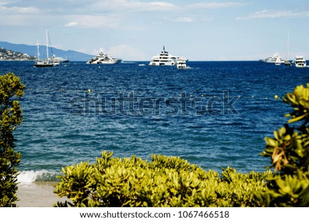 Panoramic view of ships, yachts and sailing boats in a bay under a beautiful blue sky with clouds  
