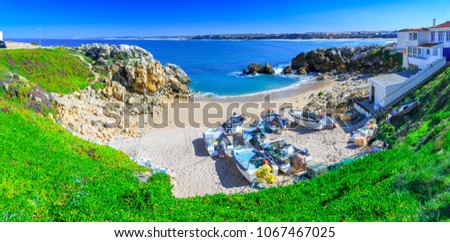 Wonderful romantic afternoon panoramic landscape. Coastline of island Baleal of the Atlantic ocean near Peniche. Fishing boat boats on the sandy shore on beach. West coast of Portugal at sunny weather