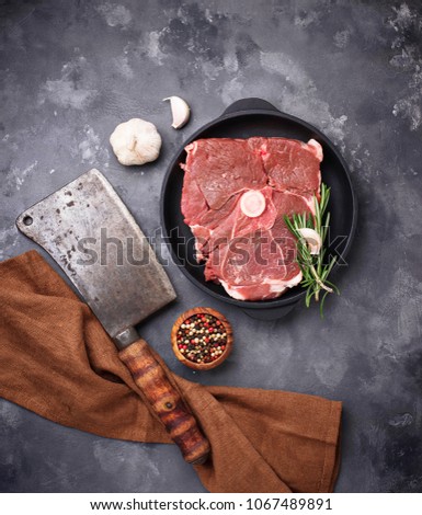 Lamb meat with rosemary, spices and cleaver. Top view