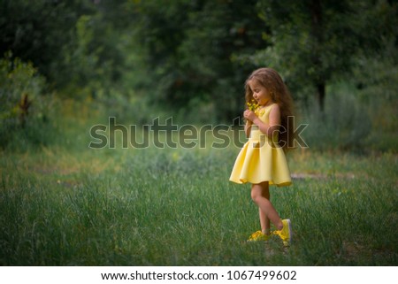 girl in a little yellow dress. Beautiful thick hair.
